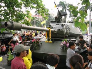 Crowd around a tank in front of Government House