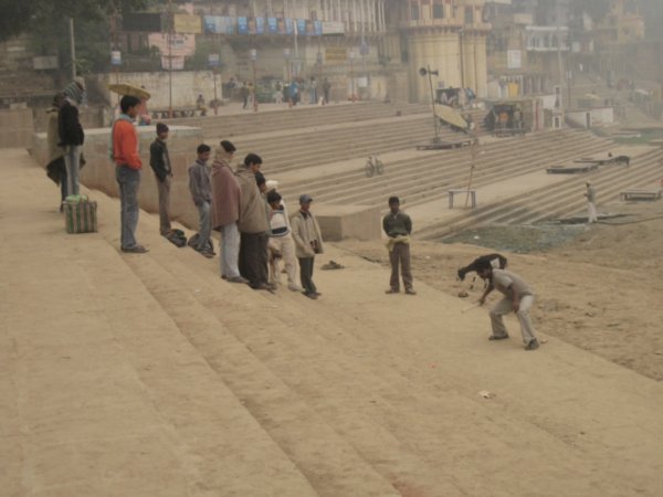 Muchachos jugando al criquet en un ghat