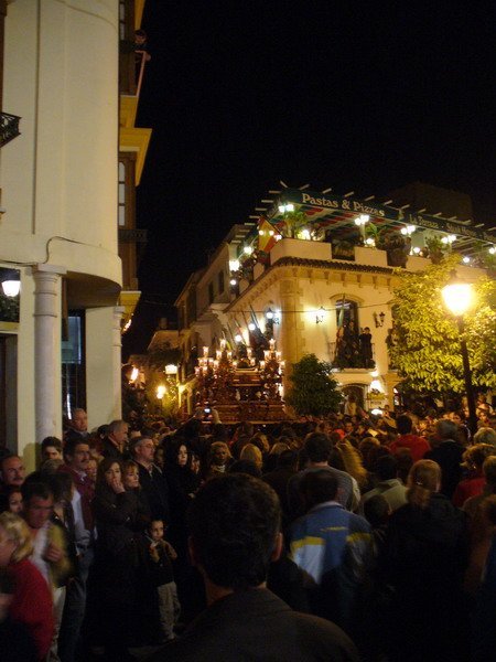 The crowd following a pasos (float) bearing 'Jesus Christ'