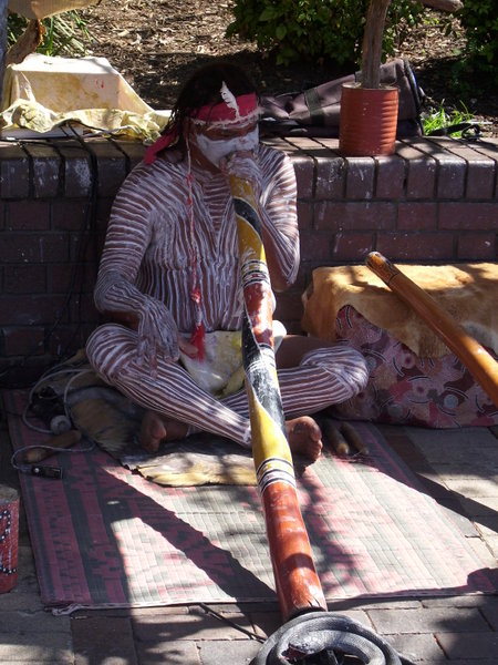 Aboriginal man playing techno didgeridoo