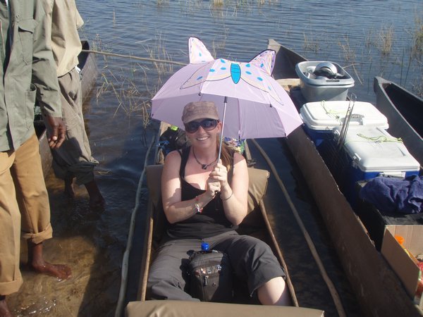 Carol and her pink umbrella in the mokoro