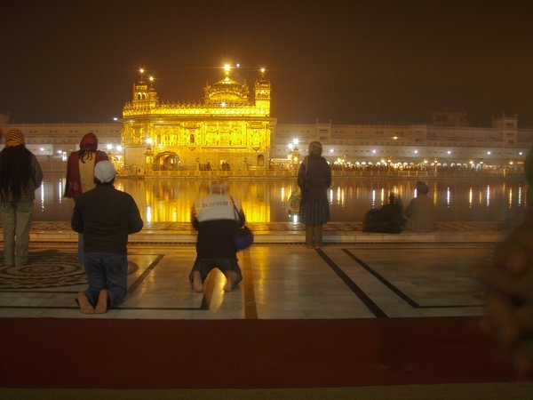 Golden temple lit up at night