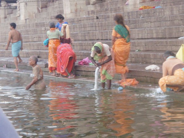 Woman bathing on the side of the Ganges River