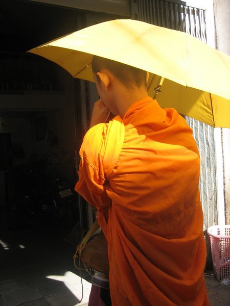 Monk taking cover from the sun