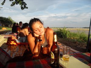 Holly enjoying evening sunshine next to Mekong