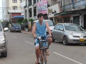 Kev cycling through the streets of Vientiane
