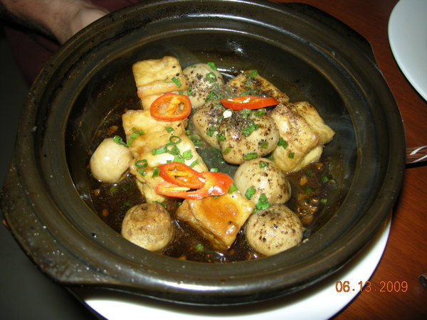 Tofu and mushrooms in a clay pot