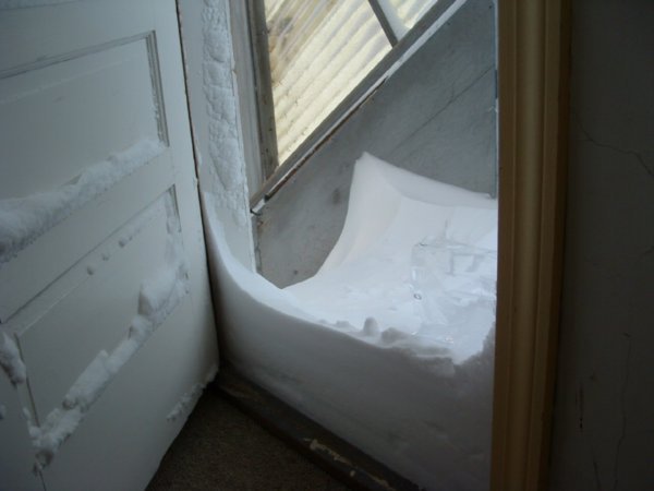 This is snow blown into an enclosed back staircase