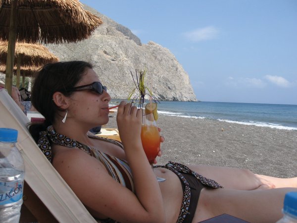 enjoying a drink on a black sand beach