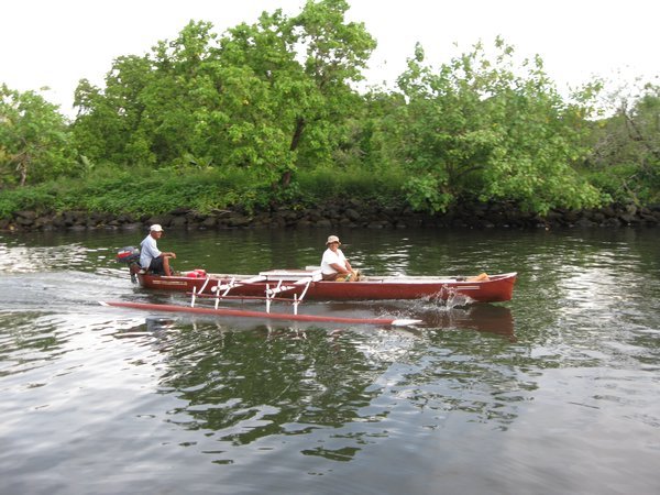 Tatau and wife in their motorized dugout canoe
