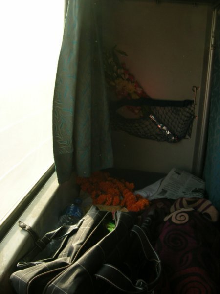 My sleeper compartment with the flowers and the marigold garlands that the Secretary General of India gave me.