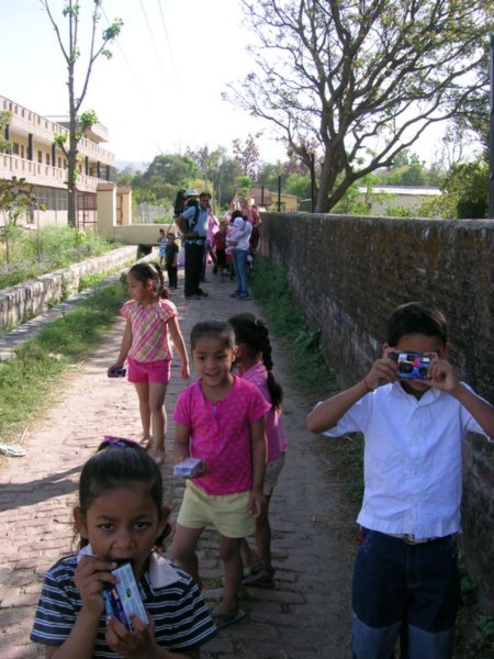 On our way to the village temple with cameras that someone gave to all the children.