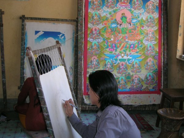 Preparing the canvas for my mandala with an unfinished painting behind.