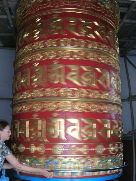 The prayer wheel with Olga giving it a spin.
