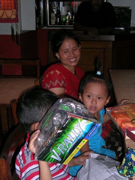 Rajan behind his present, Sushmita and their mother.