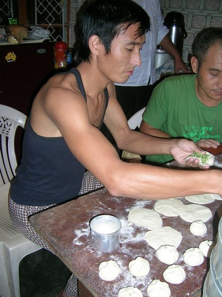 All the men help making momos.