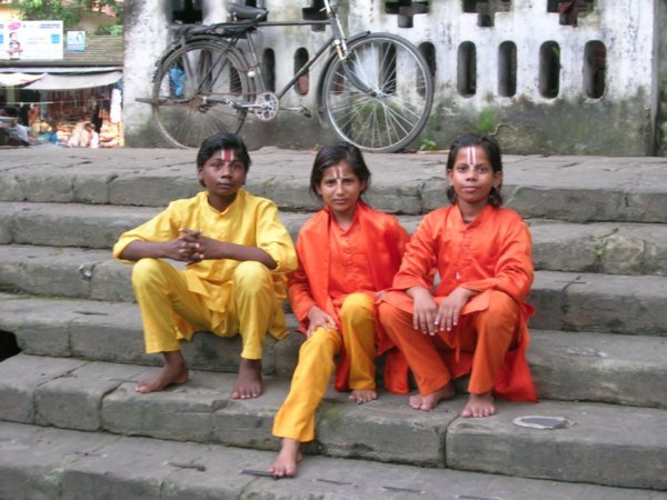 Three young devotees at a temple.