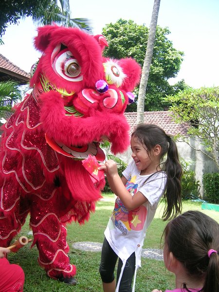 Tasha celebrating Chinese New Year with a dragon.