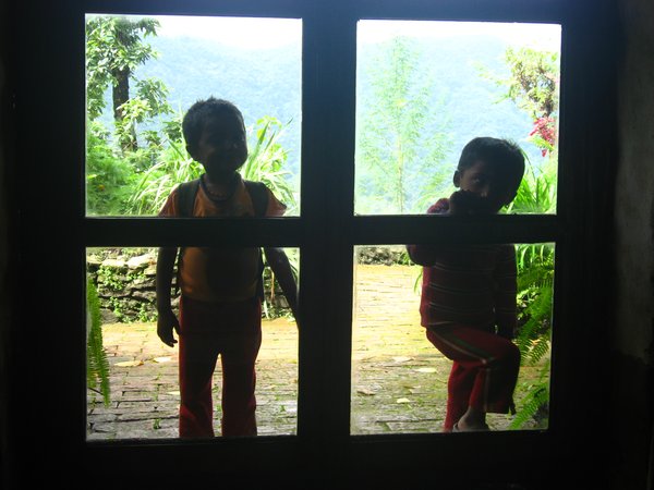 Two children peeking into our room to see the new visitors.