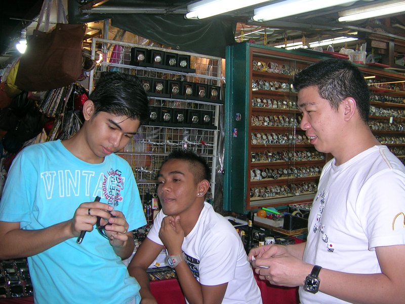 3 boys in K.L. China town trying to work out how to change the time on my watch. They eventually did it.