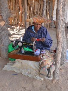 Herero woman making dolls