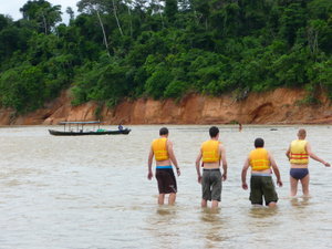 The boys wading out to help move the boat