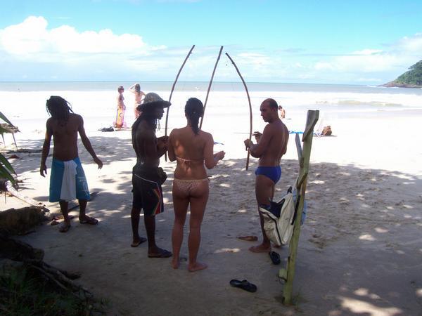 Morango, Sabine & Junior playing berimbau on the beach