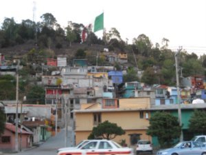Large Mexican flag on the hill over looking our (barrio) neighborhood