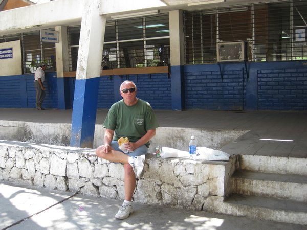 Siesta time.  Raymondo cooling his heels waiting for the El Salvadorian official to stamp his vehicle exit permit.