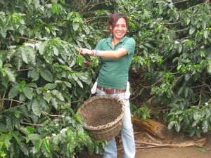 Adrianna demonstrating how a coffee bean picker carries his basket.