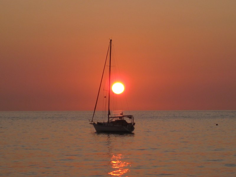 Sunset at Chacala.  Being January, we do not often get to see the sunset into the ocean. Nice of those folks to park their sailboat here for our photo op.