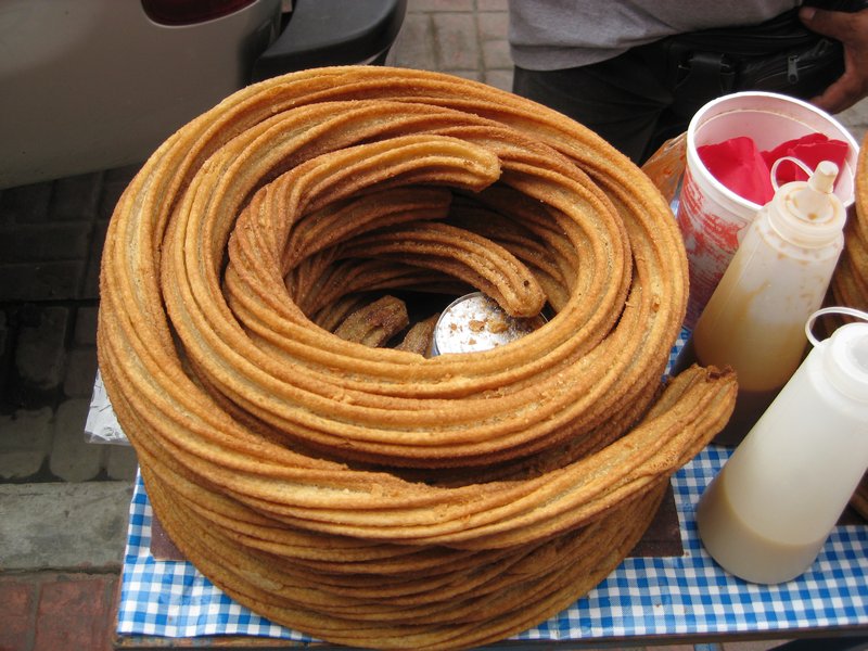 Churros, here they swirl and fry them in hot oil.  