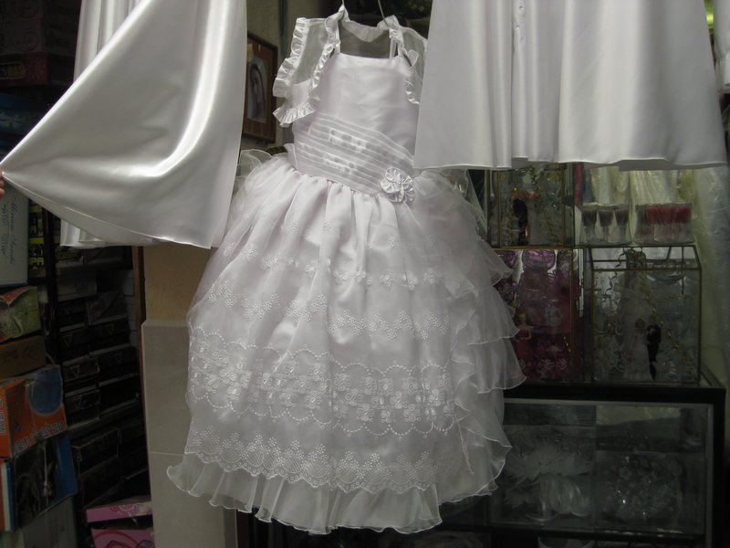 Given its size, I assume that this is a first communion dress with spaghetti straps and cute little bolero.  For sale at the street market.  I didn’t think to look at the price.