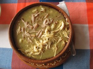 Pozole is made with pork or chicken, hominy, chiles, onions, garlic and spices.