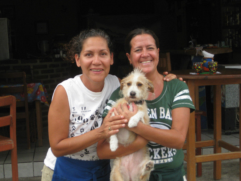 Norma, Deb and their dog Frieda outside their restaurant, Pata's.
