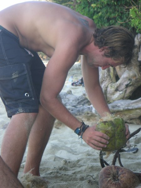 Drew busting open a coconut the old fashioned way