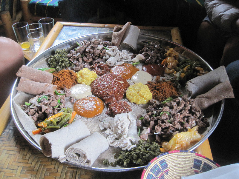 A beautiful Ethiopian food platter with injera and many spiced sauces.