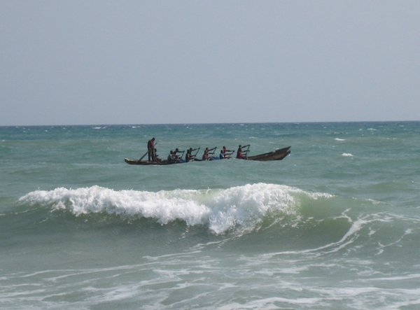 Canoe braving the waves.