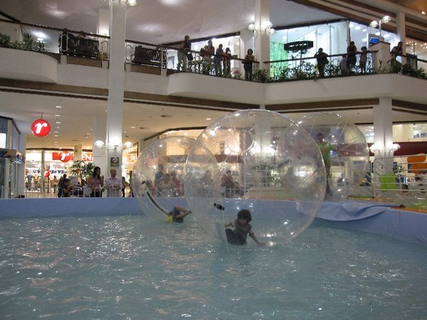 children in plastic bubbles in the mall