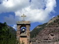 The Catholic church bell tower competes with mountain scenery