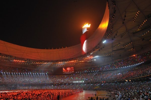 The Cauldron blazes above the stadium