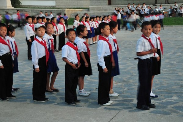 Curious and friendly children at rehearsing for National Day celebrations in Sariwon - North Korea
