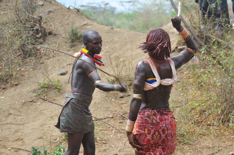 A woman is publicly whipping - Hamer initiation ceremony - Turmi, Omo Valley, Ethiopia