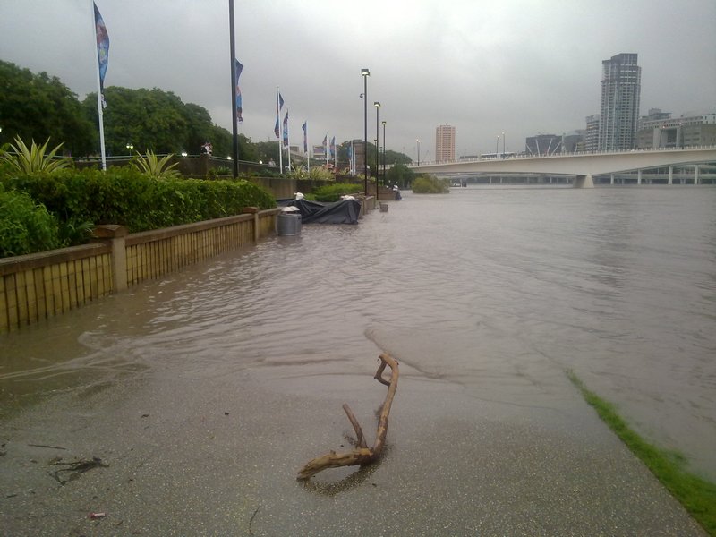 The water flowed over the high wall near the flagpoles on the middle left of the picture - 11 Jan - Brisbane, Australia.