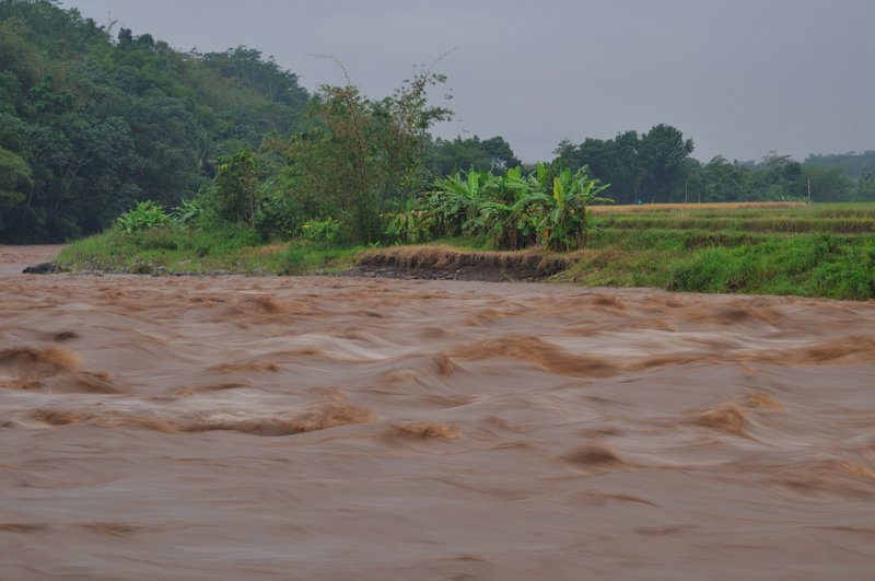 Fast flowing Progo River after storms - Puri Asri Resort, Magelang, Java, Indonesia