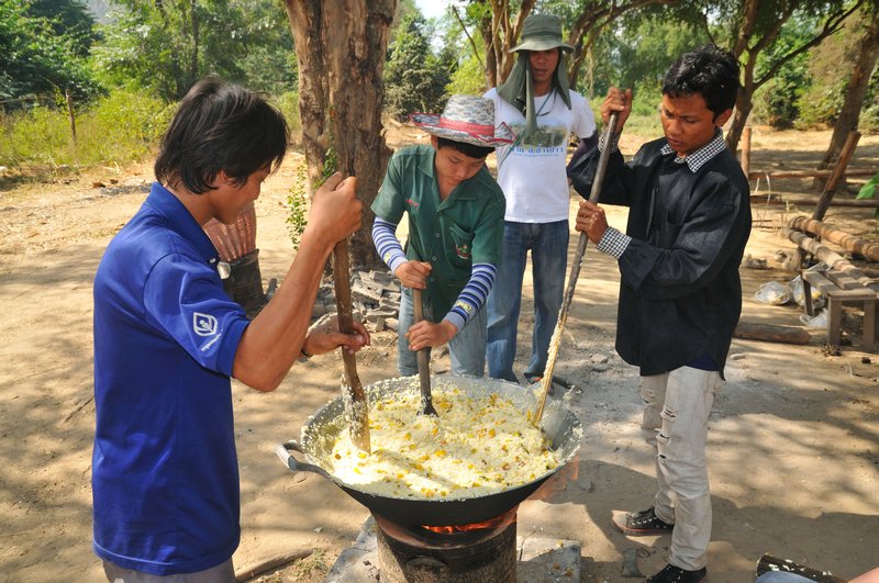 Stirring the sticky rice ball mixture - Elephant's World, Kanchanaburi, Thailand.