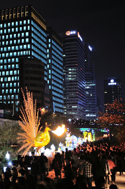 Fire-breathing peacock and cityscape - Seoul Lantern Festival, South Korea