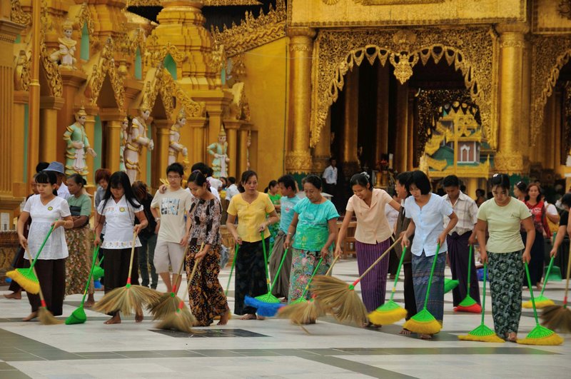 Women sweeping before sunset prayers - Shwedagon Paya, Yangon, Myanmar