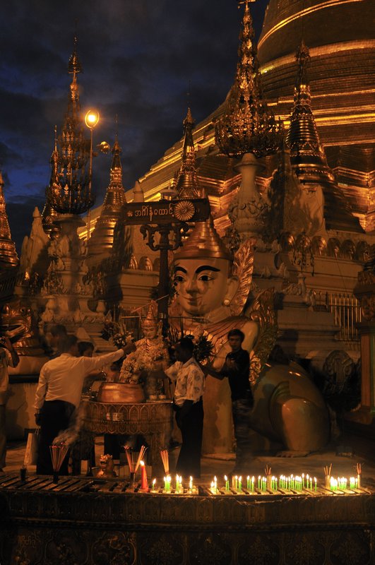 Candles lit in prayer - Shwedagon Paya, Yangon, Myanmar