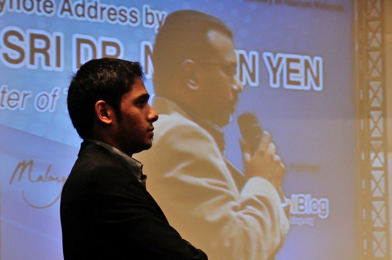 Aswin Kandasamy watches Anand Vadivelu on stage giving the closing address - MITBCA, Kuala Lumpur, Malaysia